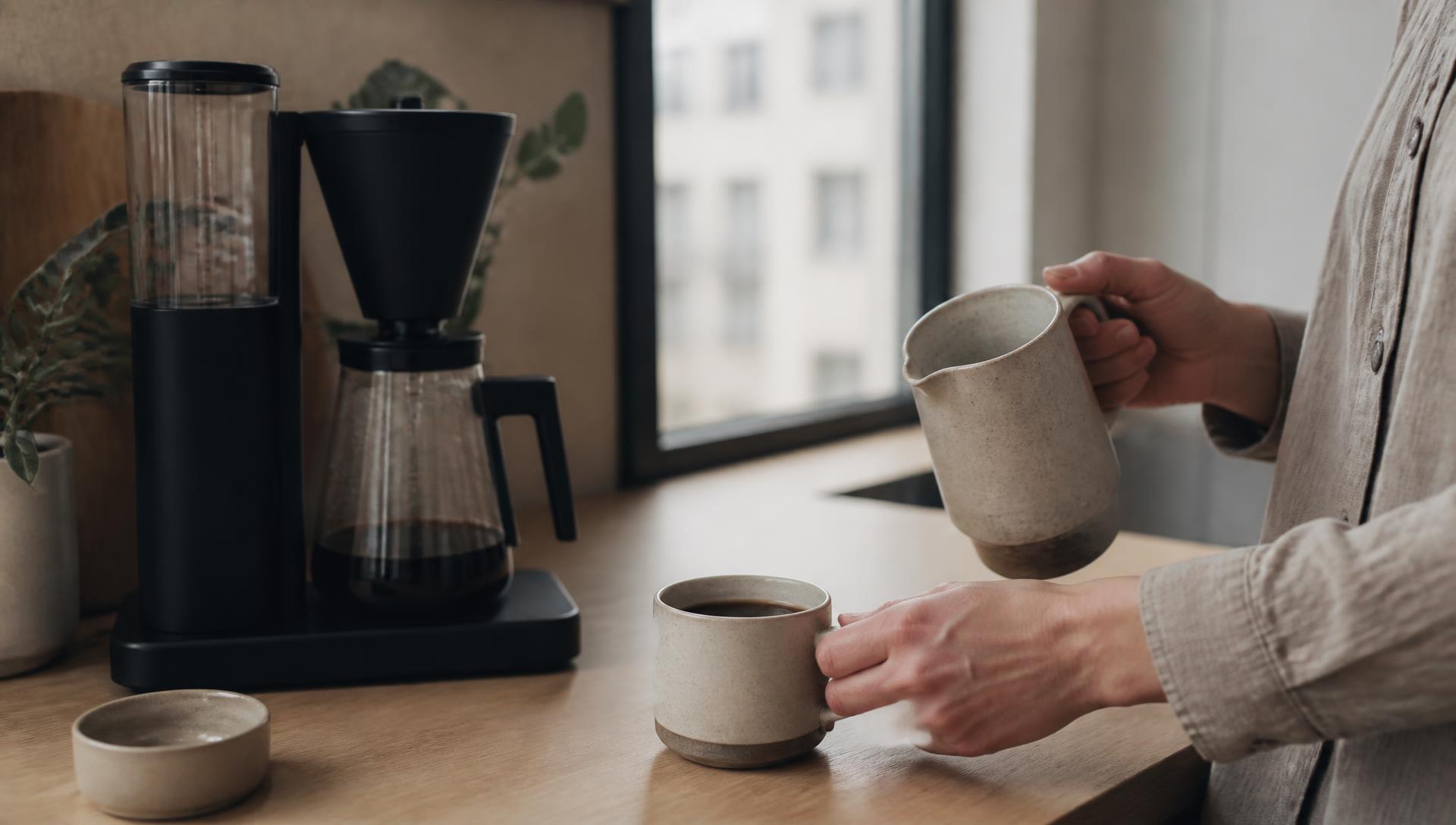Coffee being poured in a bright workplace